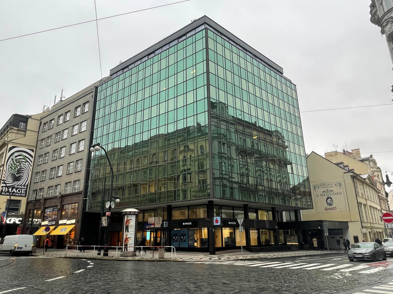 Glass office building on a street corner in central Prague where the Prague Product & Technology Office is located